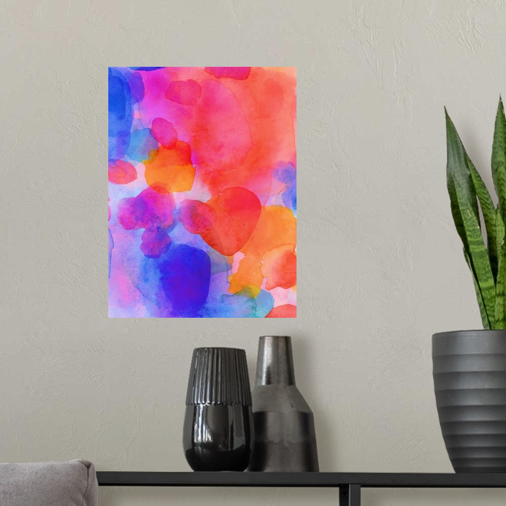 A modern room featuring A vertical abstract watercolor painting in brilliant colors of pink, orange and blue.
