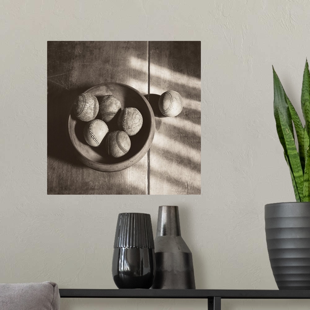A modern room featuring Photograph in sepia tones of a bowl of baseballs by Judy B. Messer.