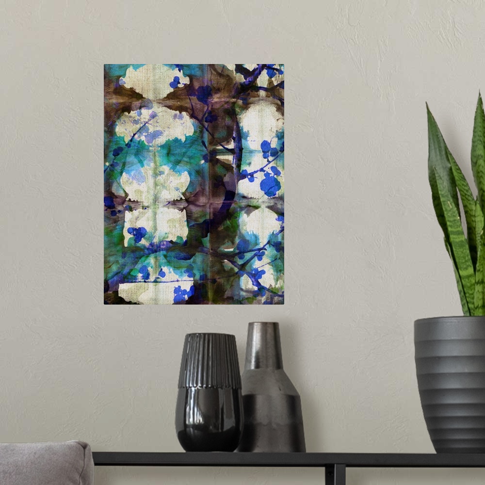 A modern room featuring A shibori painting with colorful folds and branches of cherry blossoms.