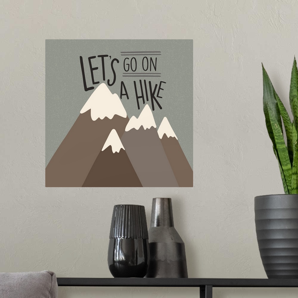 A modern room featuring "Let's go on a hike" written above a simple drawing of mountains.