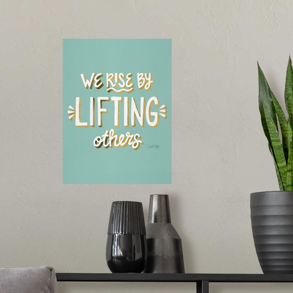 A modern room featuring We Rise By Lifting Others