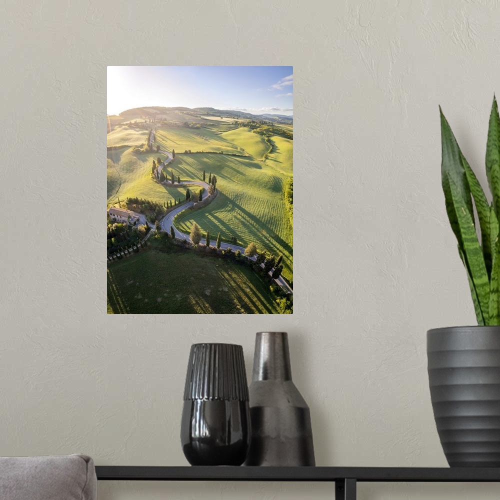 A modern room featuring iconic cypresses road of Monticchiello at sunrise. Pienza, Orcia Valley, Siena district, Tuscany,...
