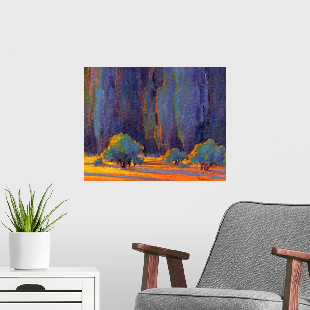 A modern room featuring Horizontal painting of a row of trees in shades of blue, orange and green.