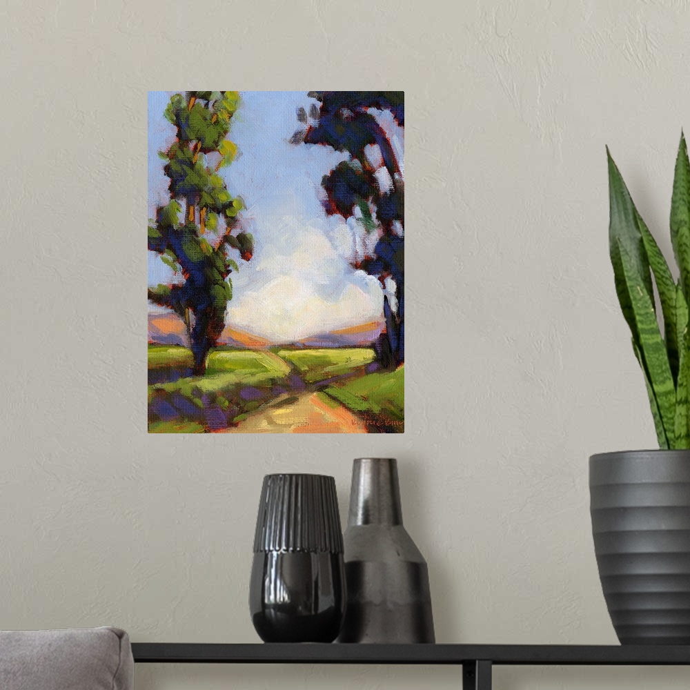 A modern room featuring Vertical painting of a country road framed by two large trees.