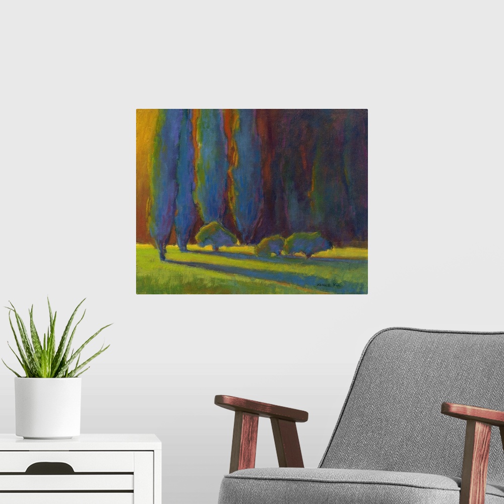 A modern room featuring Horizontal painting of a row of trees in shades of blue, orange and green.
