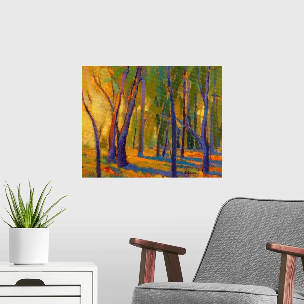 A modern room featuring Contemporary painting of trees in a forest with strong golden light shining through at golden hour.