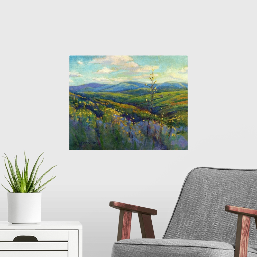 A modern room featuring A contemporary painting of a row of wild flowers and rolling hills in vibrant colors.