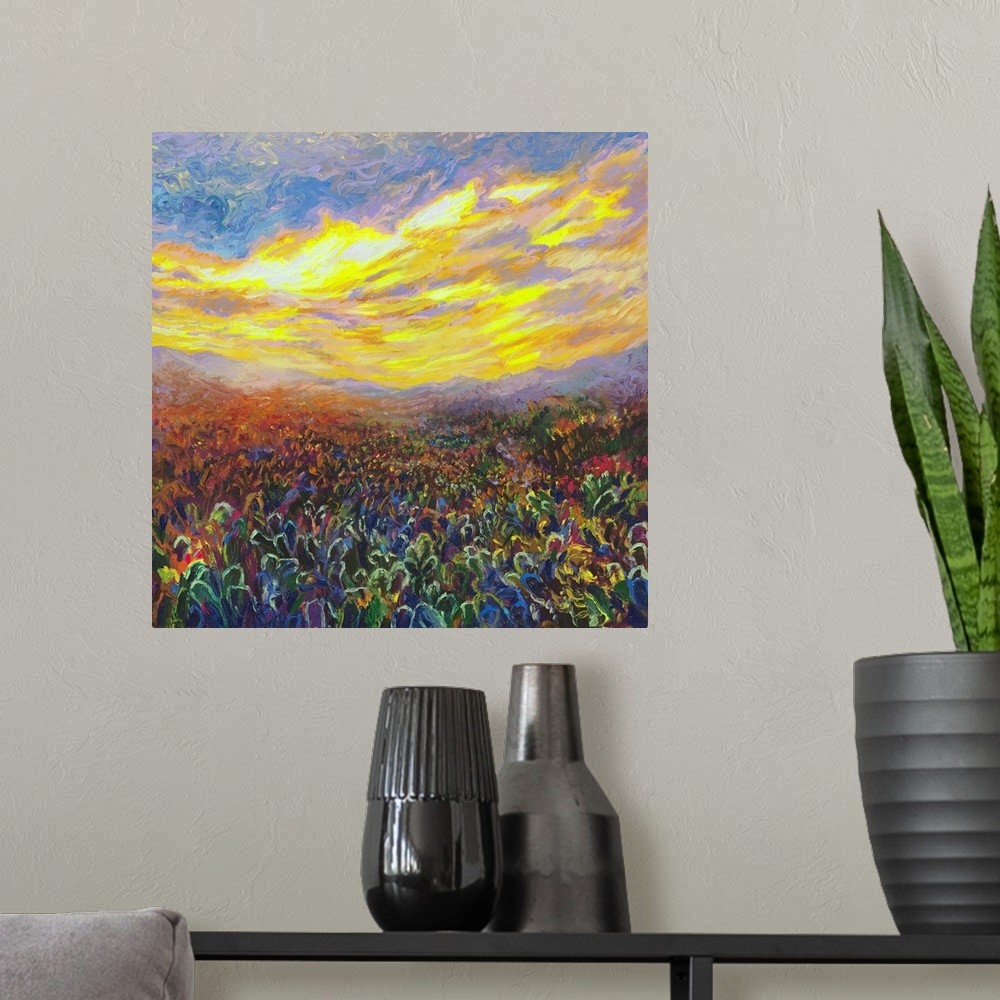 A modern room featuring Brightly colored contemporary artwork of a field of cacti at sunrise.