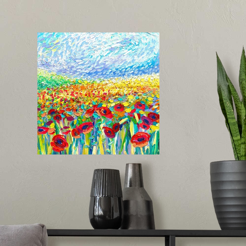 A modern room featuring Brightly colored contemporary artwork of a painting of a field of red and yellow poppies.