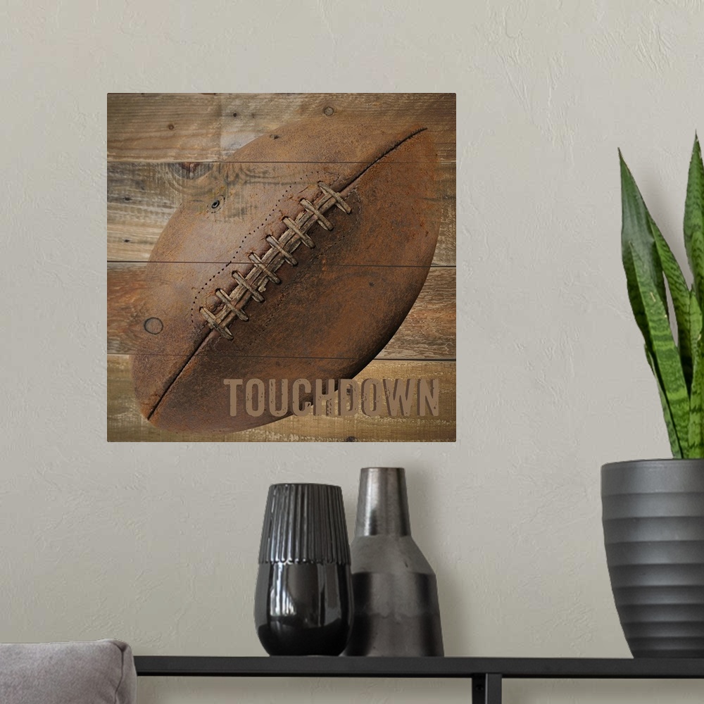 A modern room featuring Image of a football with the word "Touchdown" on a wooden background.