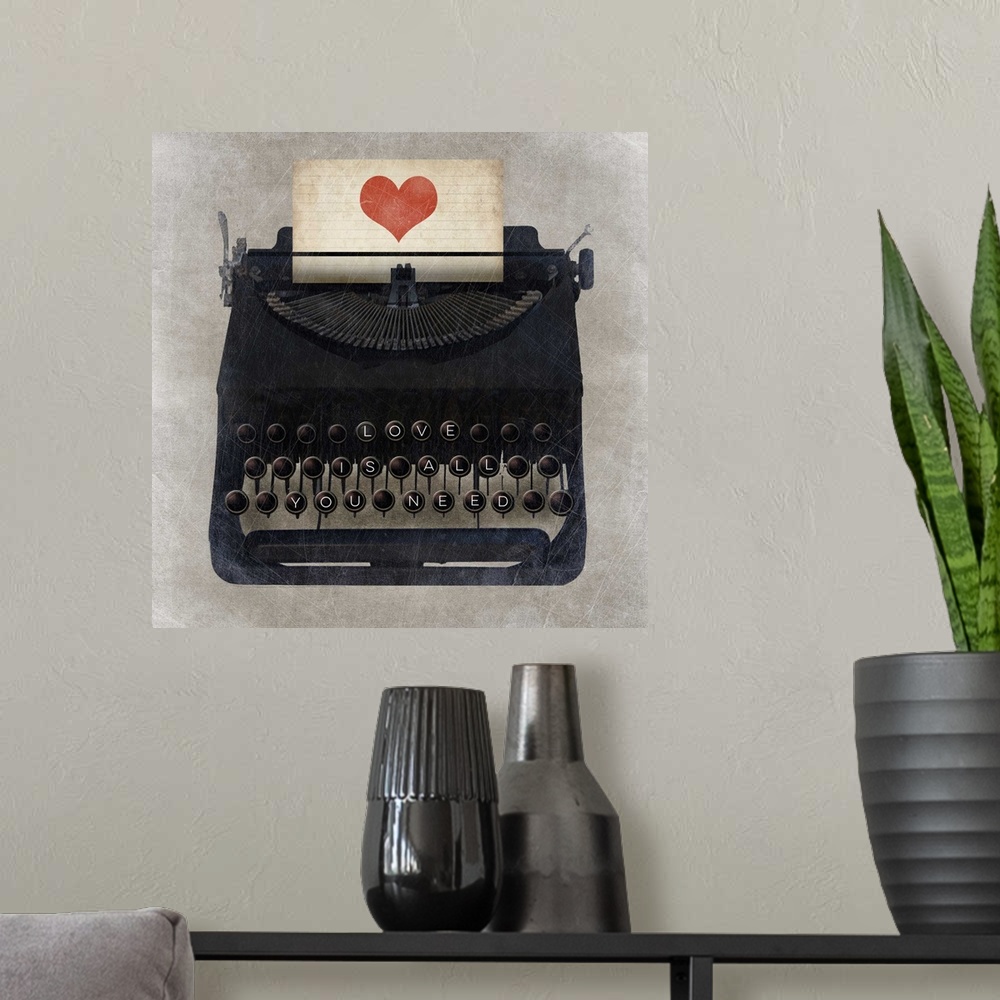 A modern room featuring A vintage typewriter with "Love is all you need" on the keys and a heart on the paper.