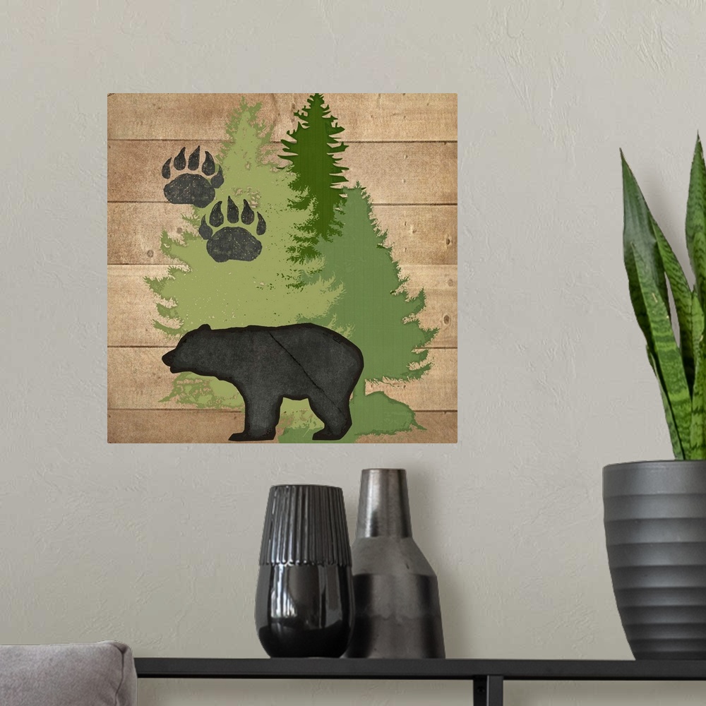 A modern room featuring Cabin decor of a bear silhouette with paw prints and pine trees.