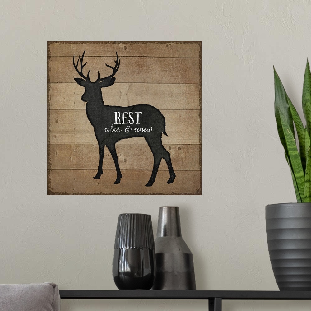 A modern room featuring Cabin decor of a deer silhouette on a wooden board background.
