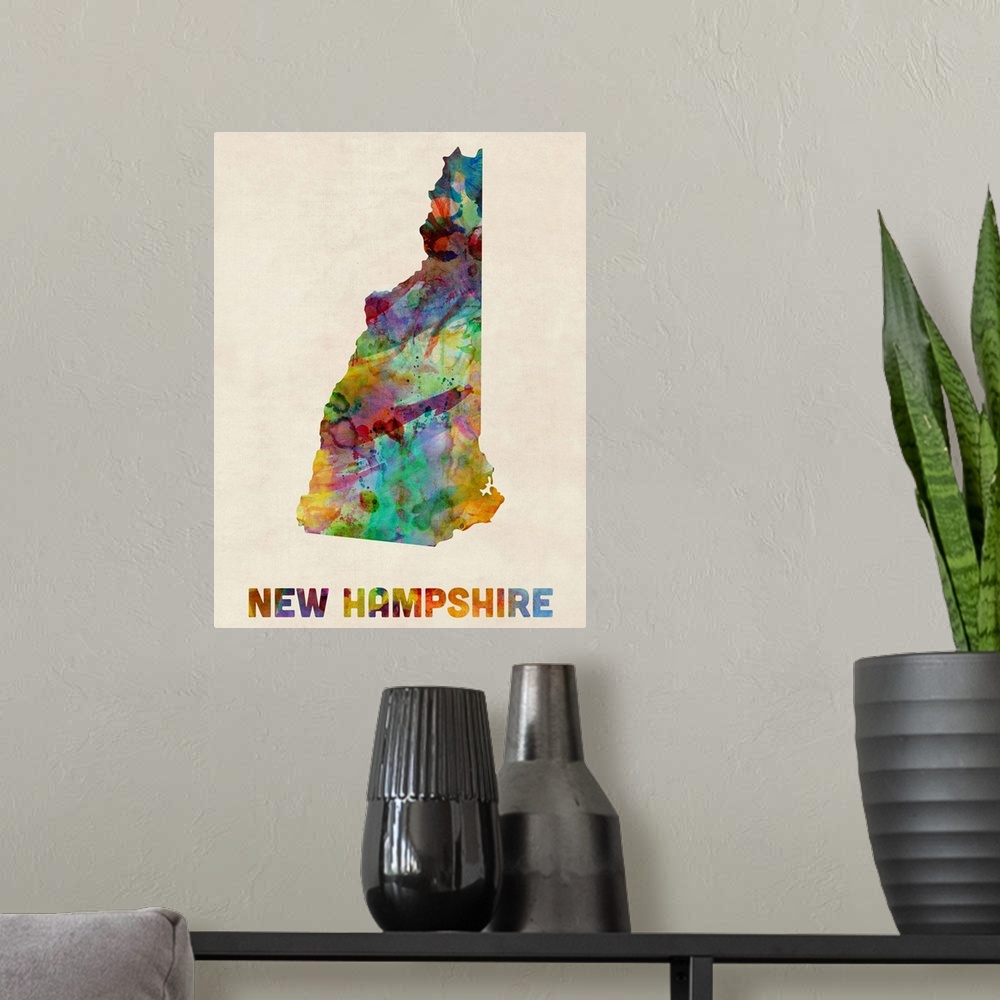 A modern room featuring Contemporary piece of artwork of a map of New Hampshire made up of watercolor splashes.