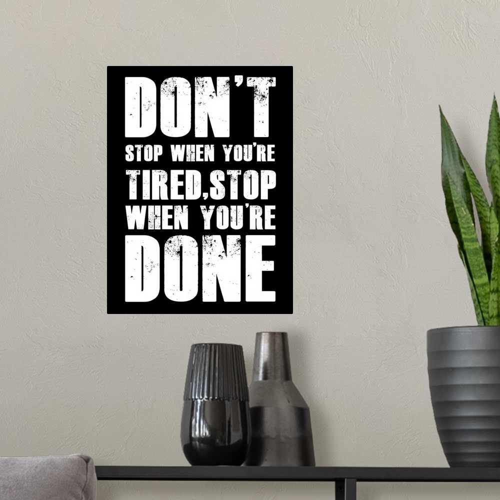 A modern room featuring A bold, masculine motivational quote on a black background. Perfect for home gym or recreation room