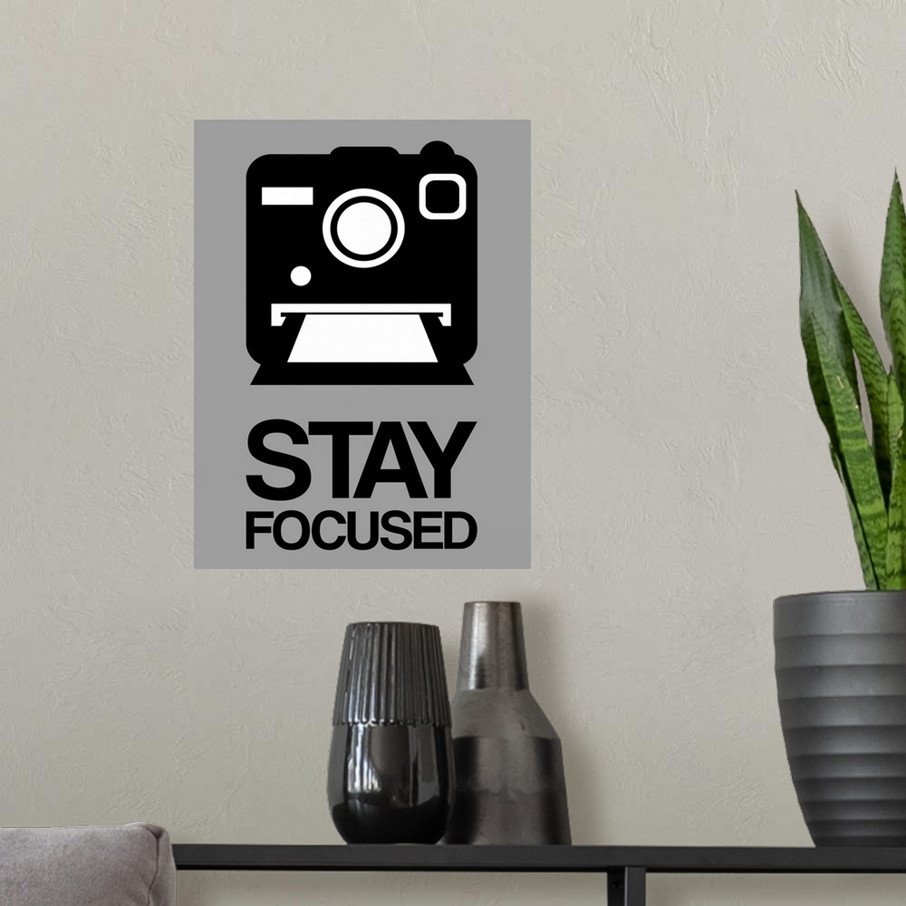A modern room featuring Stay Focused Polaroid Camera Poster I