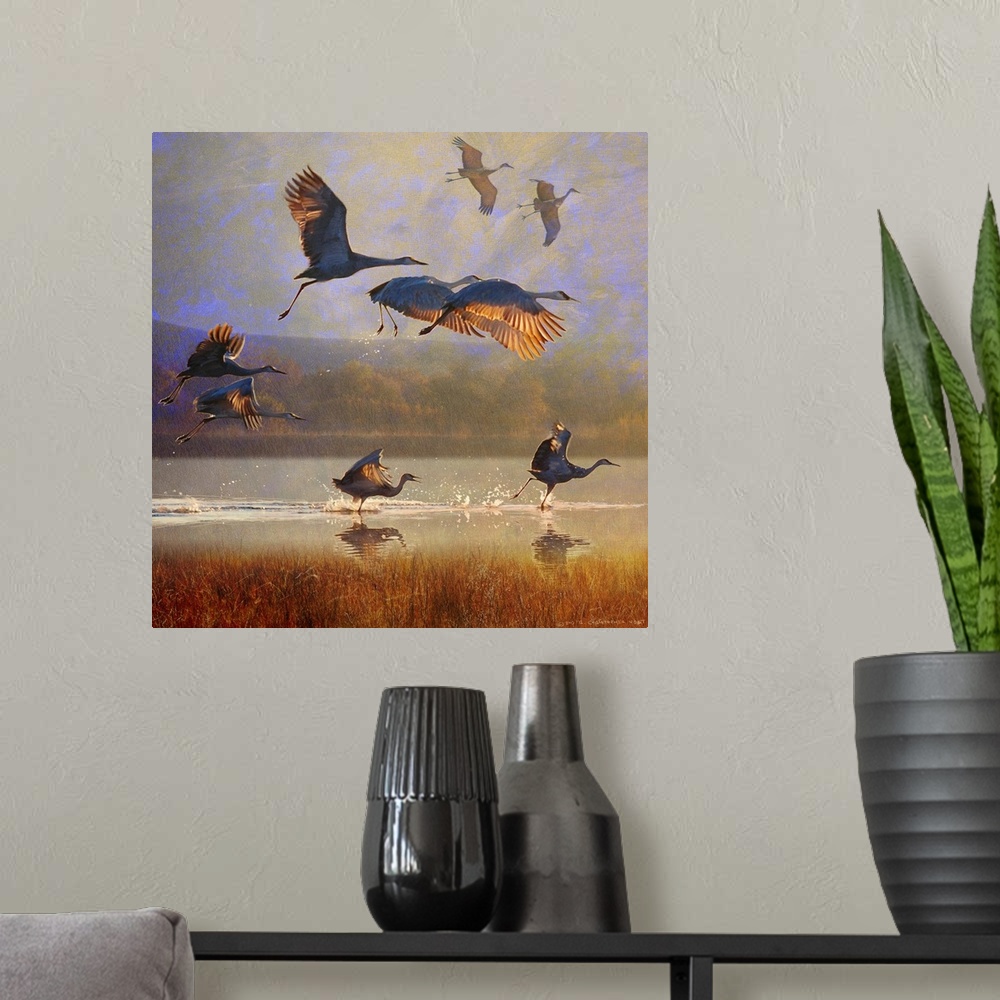 A modern room featuring Contemporary artwork of a flock of cranes taking to flight.