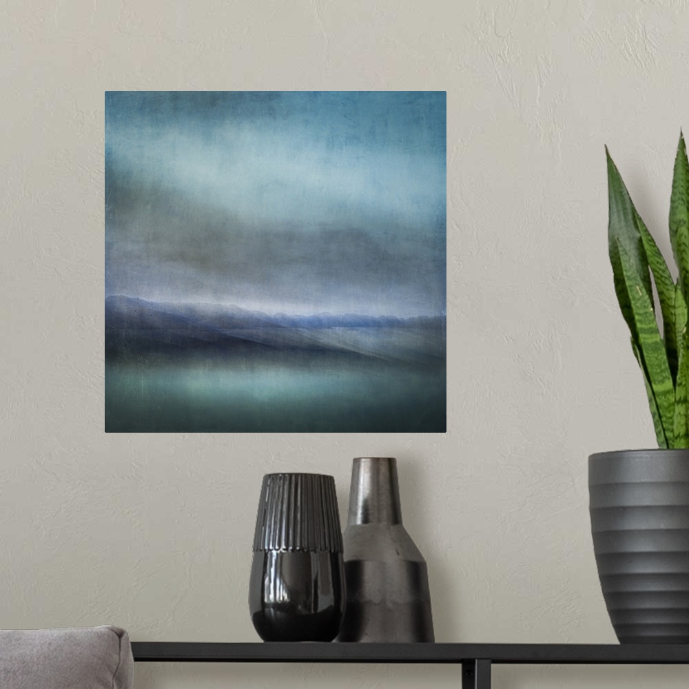 A modern room featuring Blue landscape abstract of tiny islands receding into the distance with moody skies and dark teal...