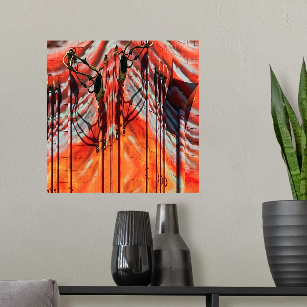 A modern room featuring Conceptual photo of red and orange painted pipes and wires on the side of a building, warped to c...