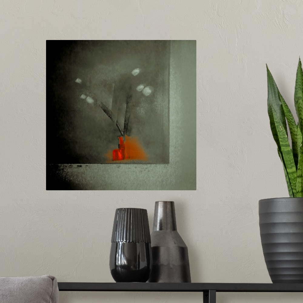 A modern room featuring Square image of a bright red vase with long stemmed flowers on a black and gray background.
