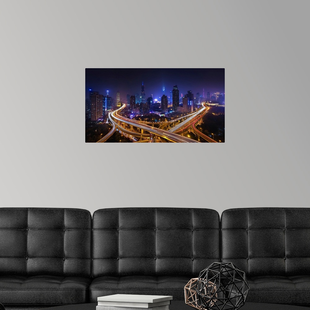 A modern room featuring Horizontal city skyline of Shanghai, China at night.