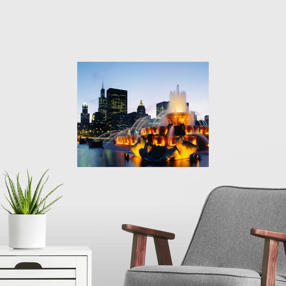 A modern room featuring Huge photograph taken of Buckingham Fountain lit up at night as it sprays water in an artful sequ...