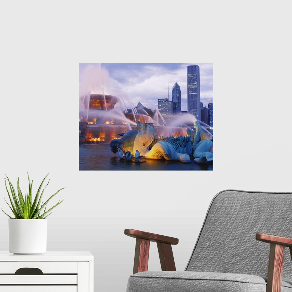 A modern room featuring Side view of the Buckingham fountain lights as night falls in Chicago.