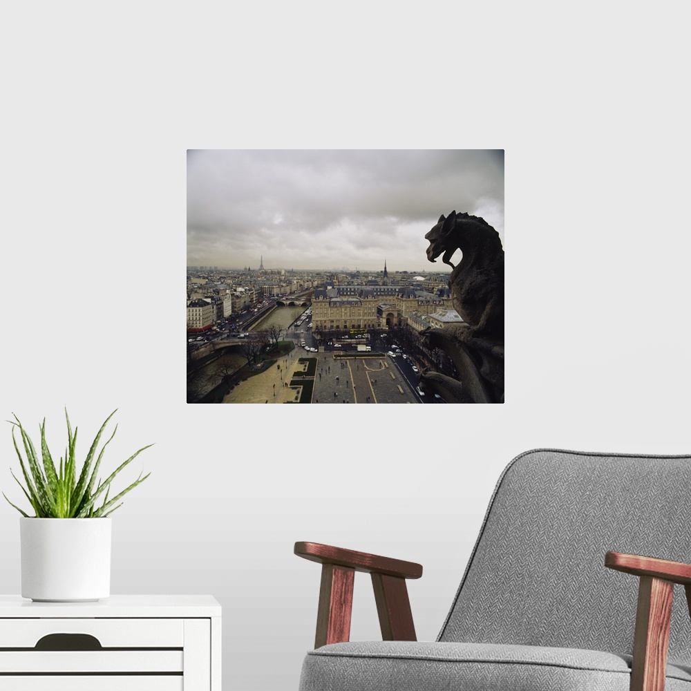 A modern room featuring Horizontal, high angle photograph on a big canvas, looking past a gargoyle from the top of Notre ...