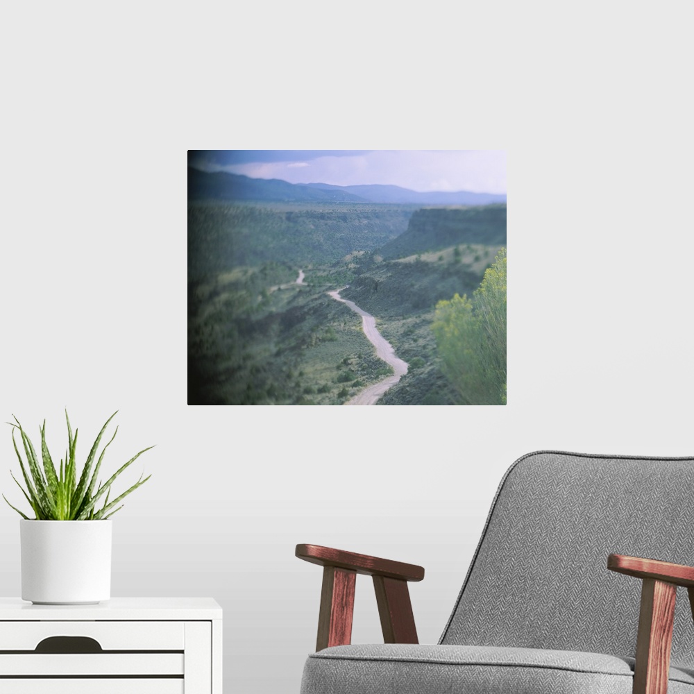 A modern room featuring High angle view of a dirt road passing through a valley, Rio Grande Gorge, Taos, Taos County, New...