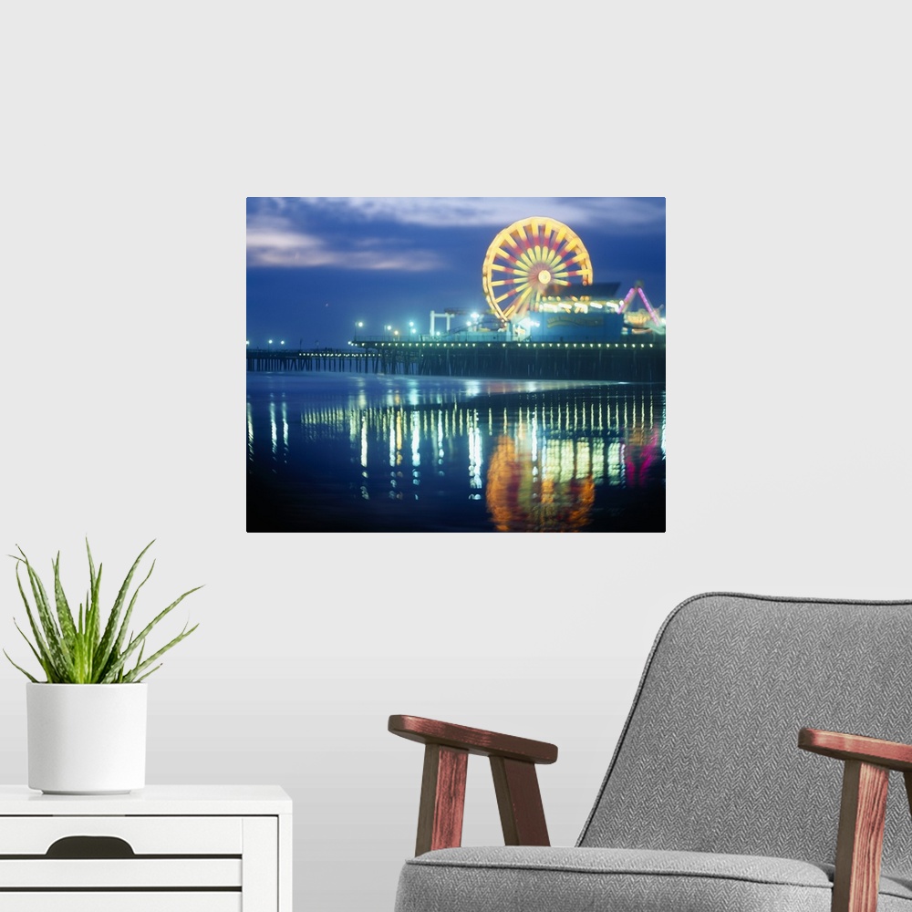 A modern room featuring Landscape, large photograph of Municipal Pier at night, reflecting in the waters in the foregroun...
