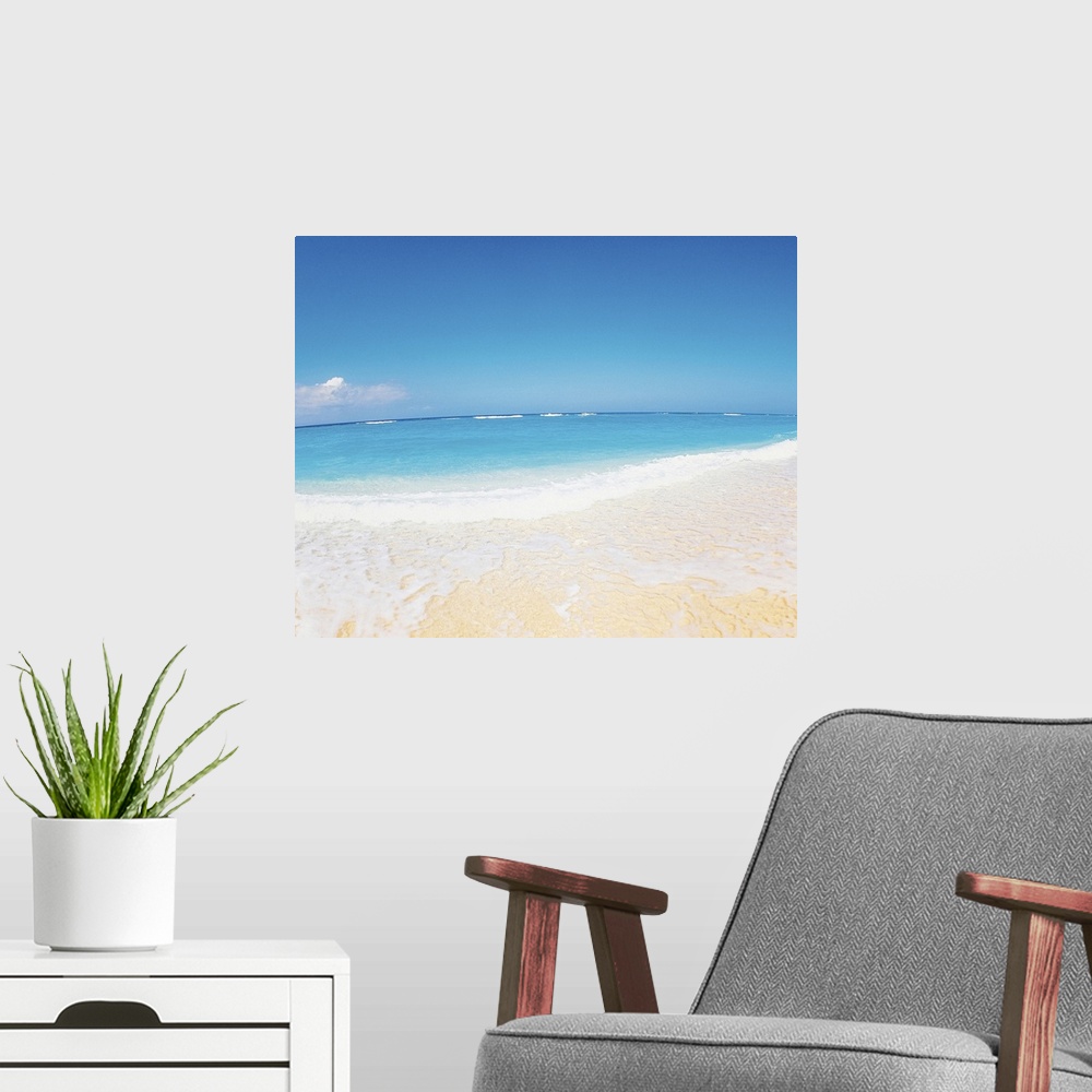 A modern room featuring Surf at seashore and blue sky in background