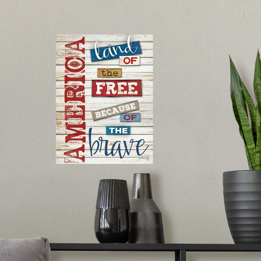 A modern room featuring Patriotic typography art in red white and blue against white distressed wooden boards.