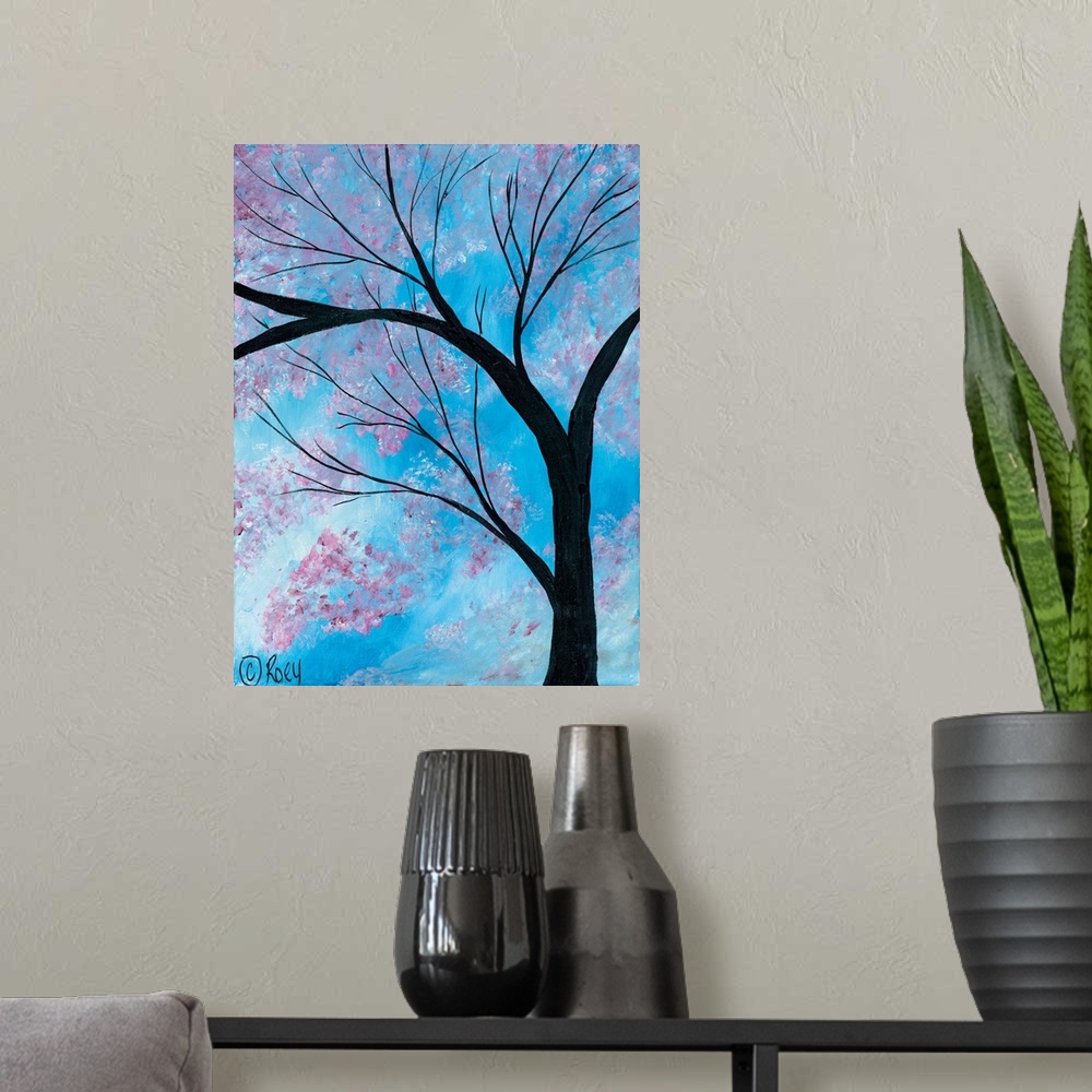 A modern room featuring Vertical contemporary painting of a Cherry Blossoms Tree surrounded by brilliant blue skies.