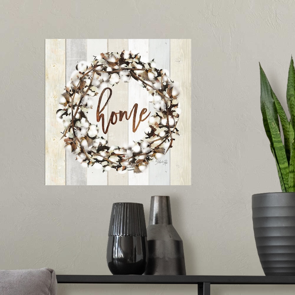 A modern room featuring "Home" in the middle of a wreath of cotton against a shiplap background.