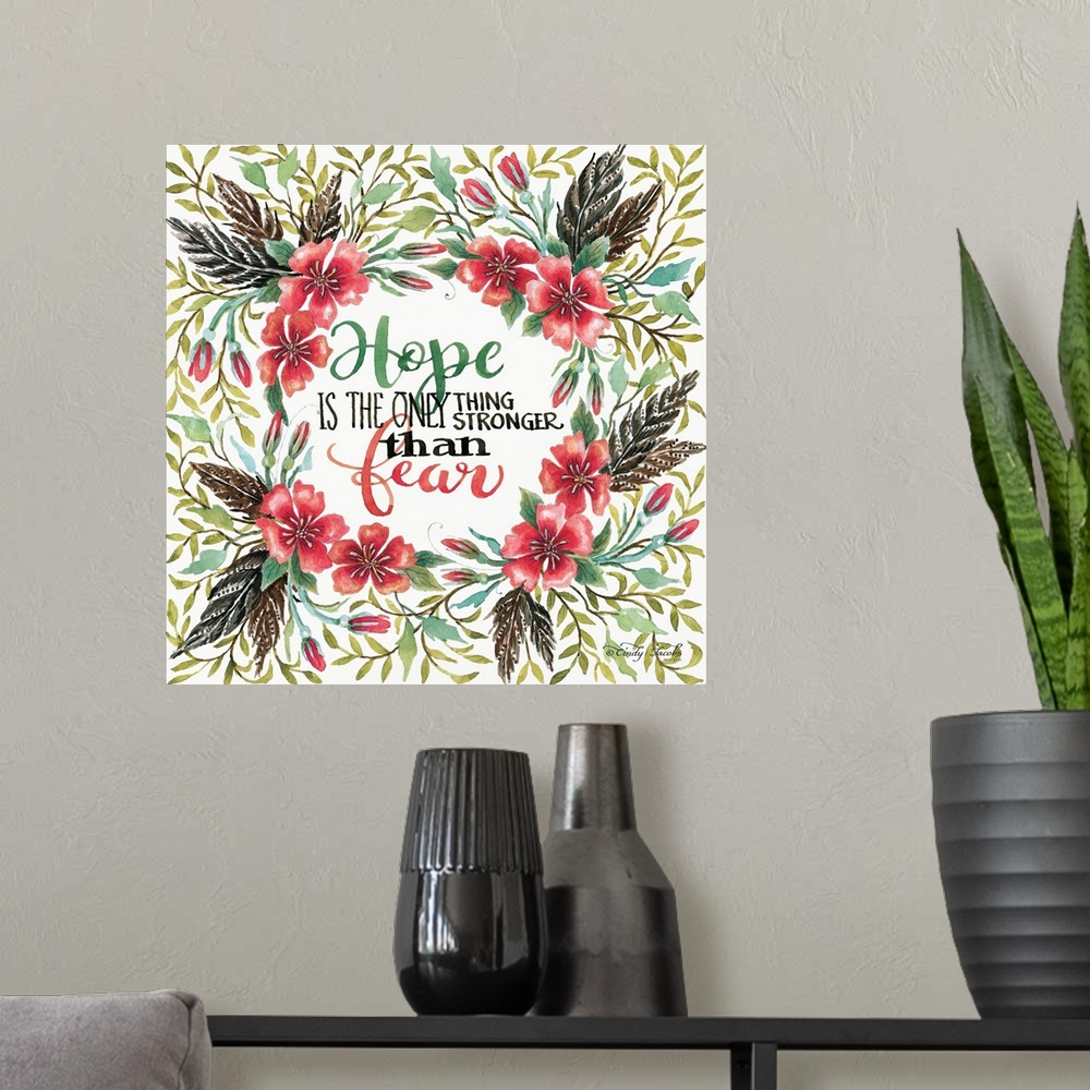A modern room featuring Handlettered sentiment in a wreath of red poppies with dark leaves.