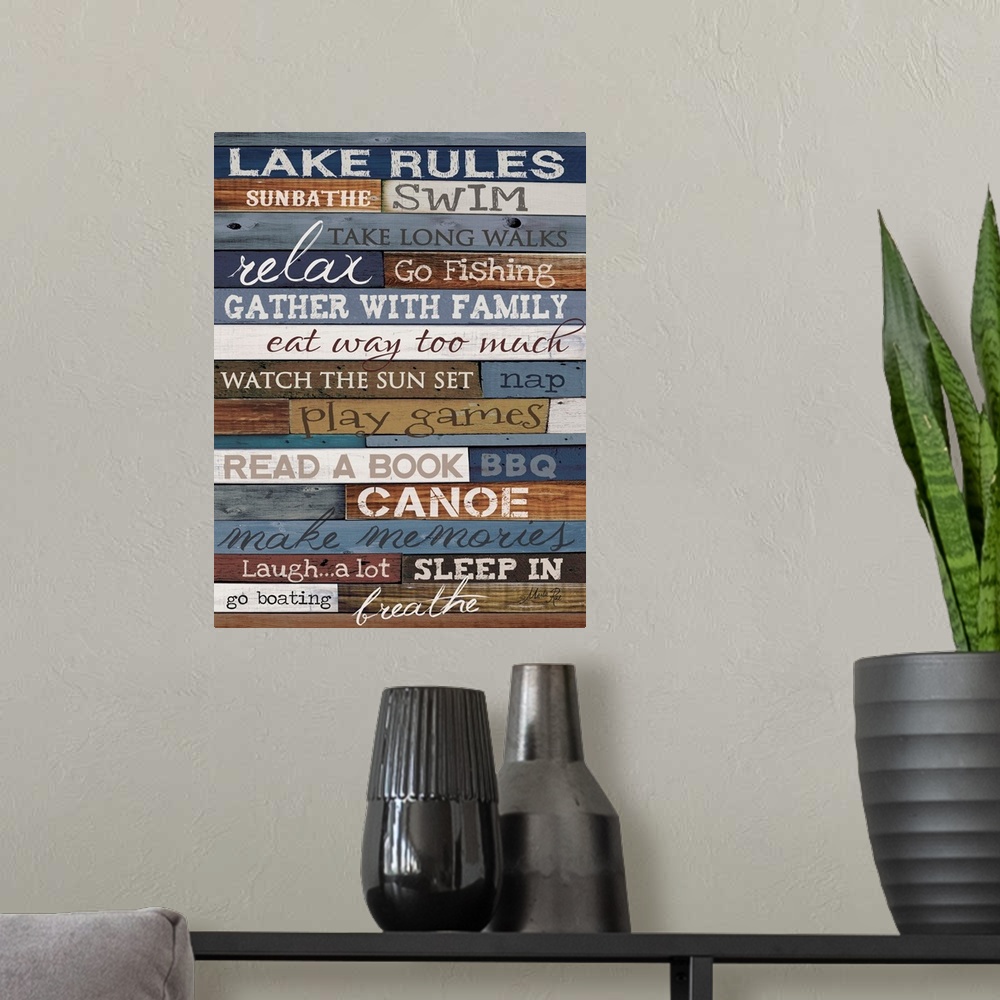 A modern room featuring Typography artwork of lake rules, with text against a wooden background.