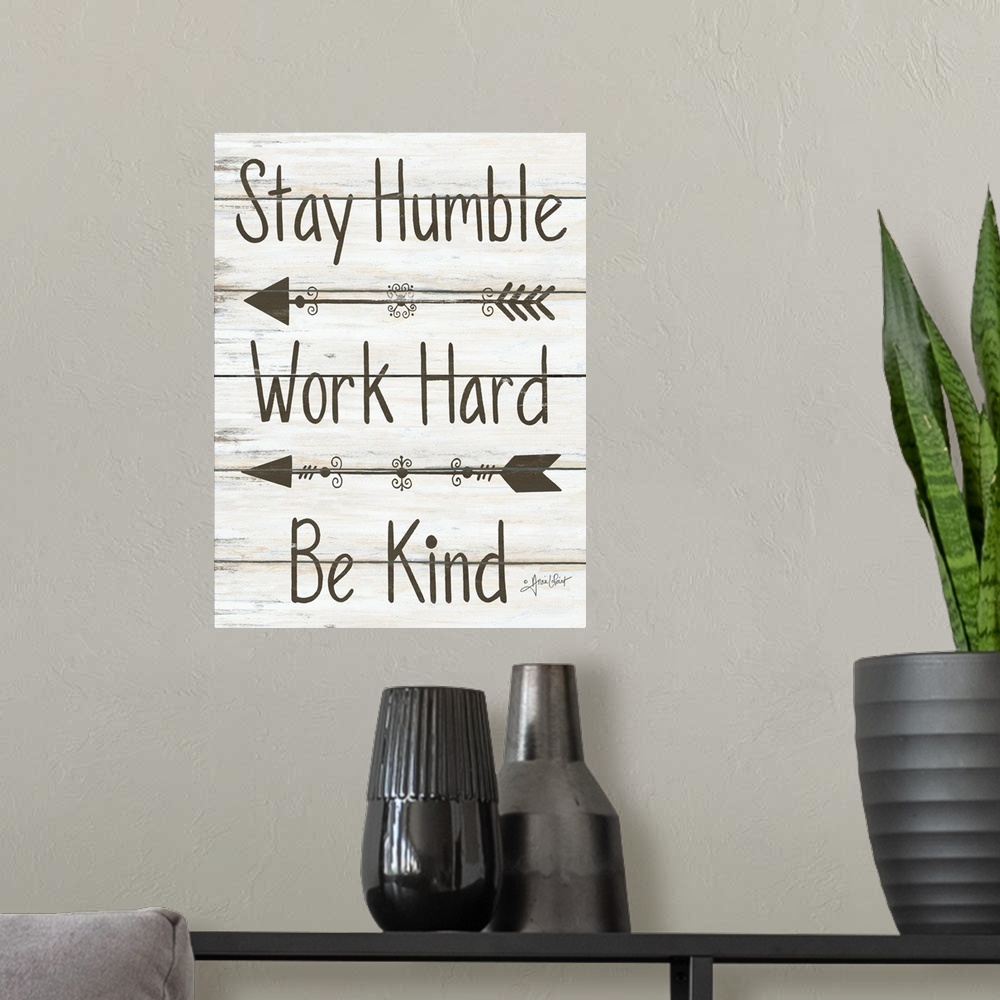 A modern room featuring This decorative artwork features the phrase: Stay humble, work hard, be kind, over a distressed w...