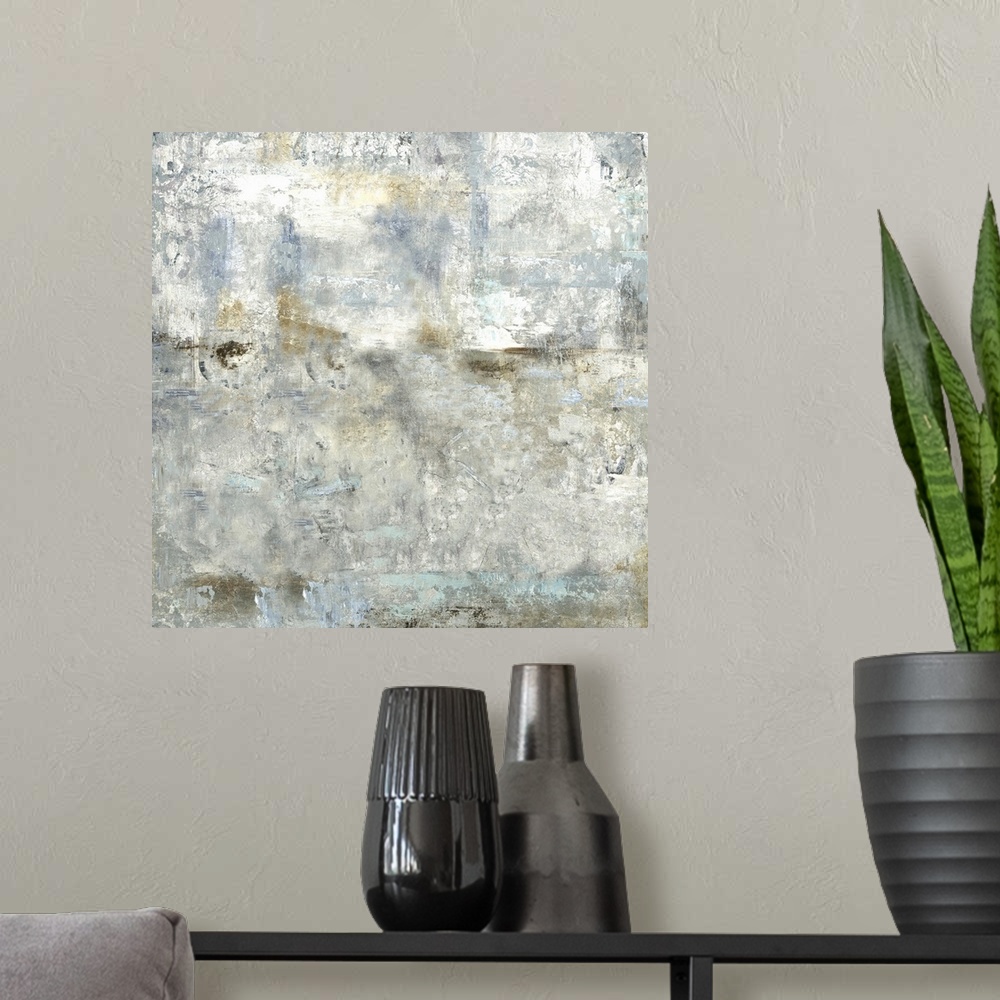 A modern room featuring Square abstract painting with cool gray, blue, and gold tones.