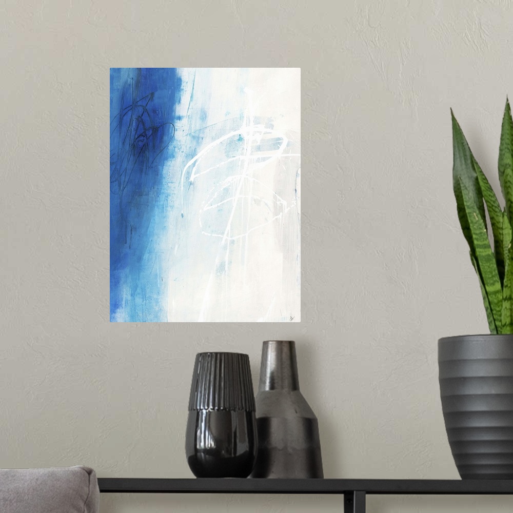 A modern room featuring Contemporary abstract painting using white and vibrant blue in vertical formation.