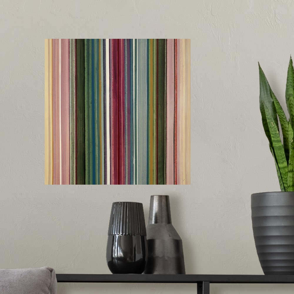 A modern room featuring Modern painting of many vertical stripes, side by side and in various colors and thicknesses.