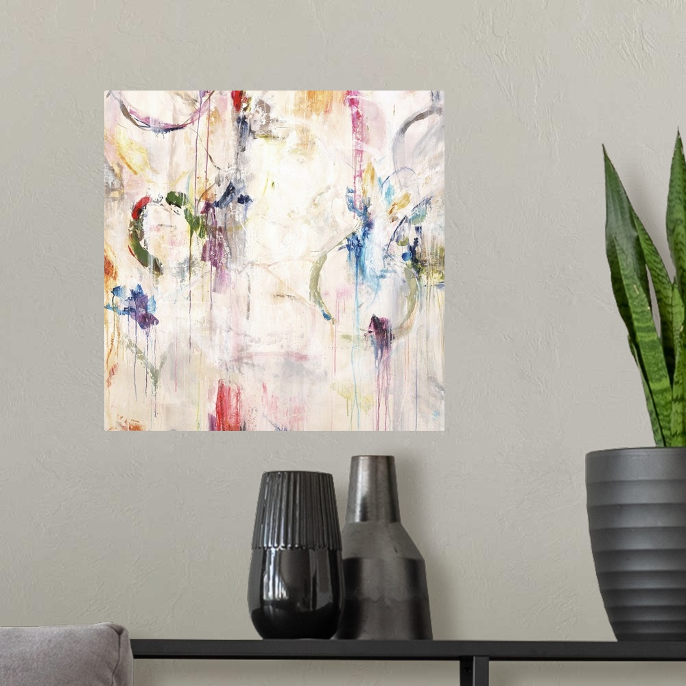 A modern room featuring Contemporary abstract painting in white with pops of bright colors in splatters and rings.