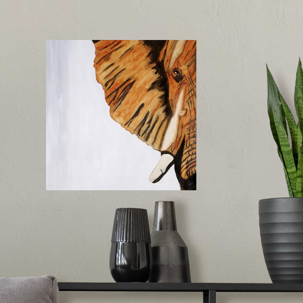 A modern room featuring Square abstract painting of half of an elephants face created with orange, white, gray, and black...