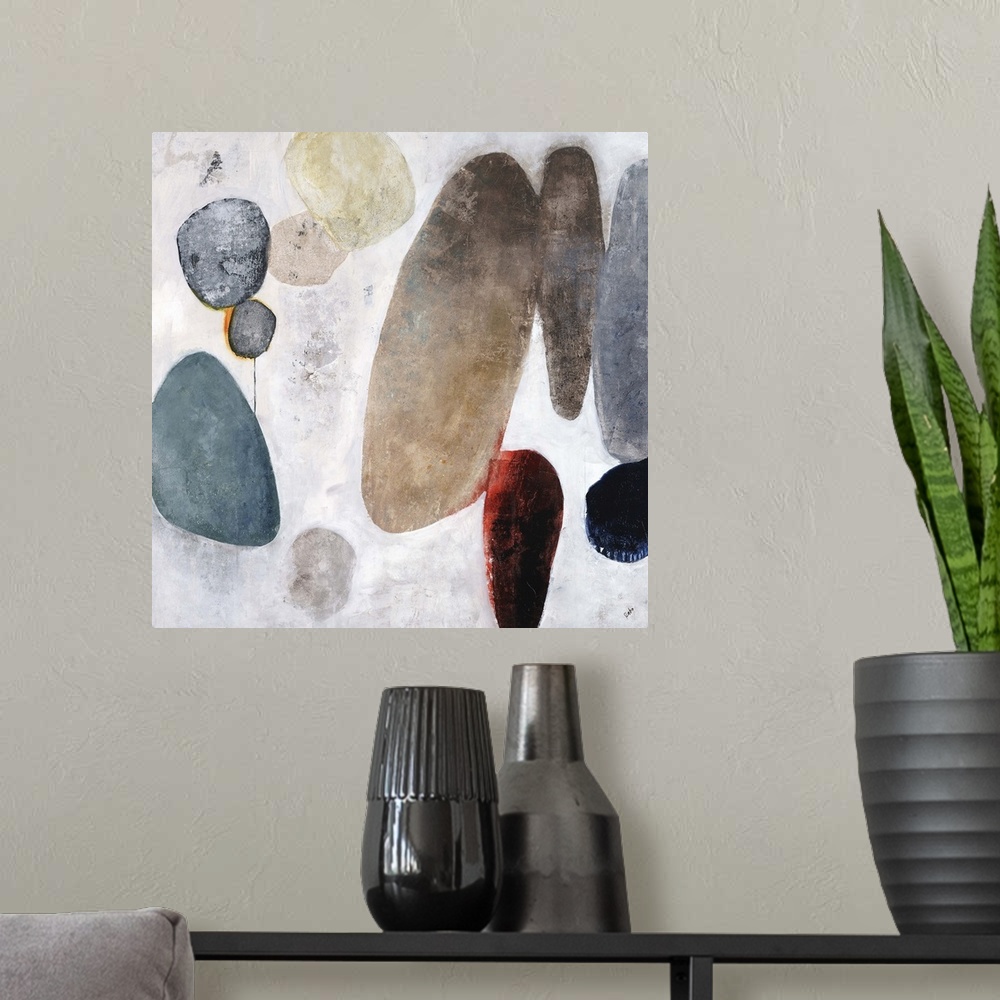 A modern room featuring Contemporary painting of a cluster of rocks in various sizes and colors, on a light background wi...