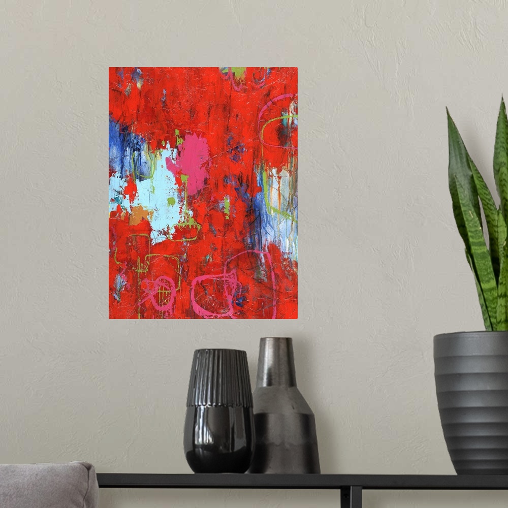 A modern room featuring Large abstract painting with bright red hues with pink and green lines on top and shades of blue ...