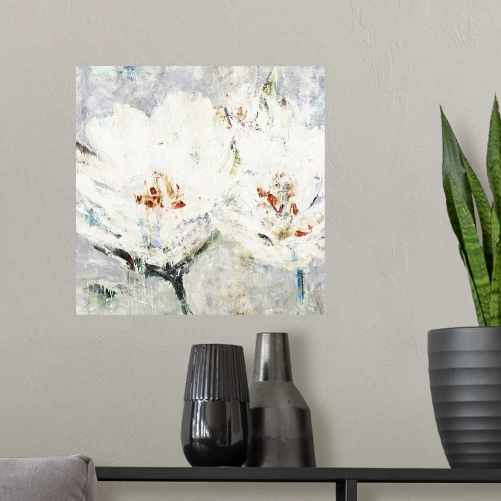 A modern room featuring Square artwork of two white flowers with orange accents in textured paint.