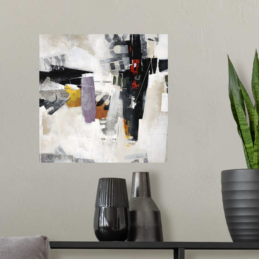 A modern room featuring Abstract art of overlapping stenciled letters and pieces of newsprint, placed randomly among patc...