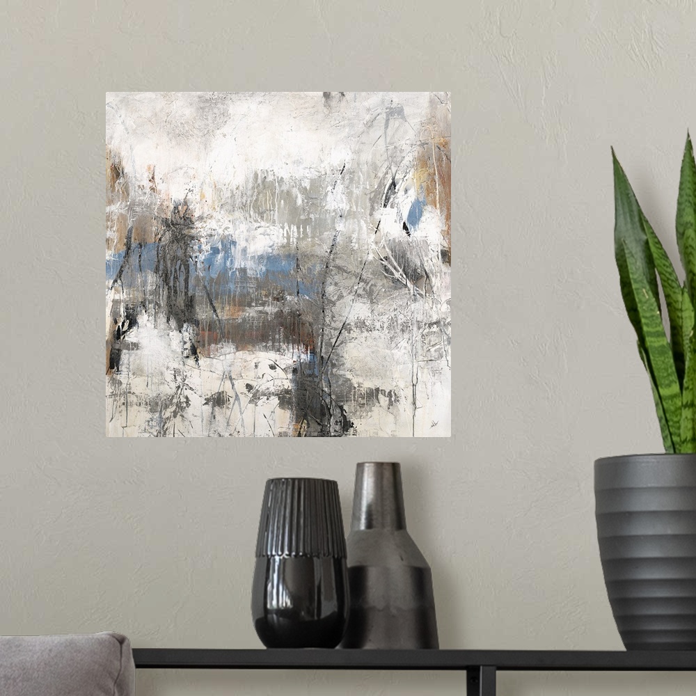 A modern room featuring Square abstract art with blue, brown, and black hues surrounded by neutral grays and whites.