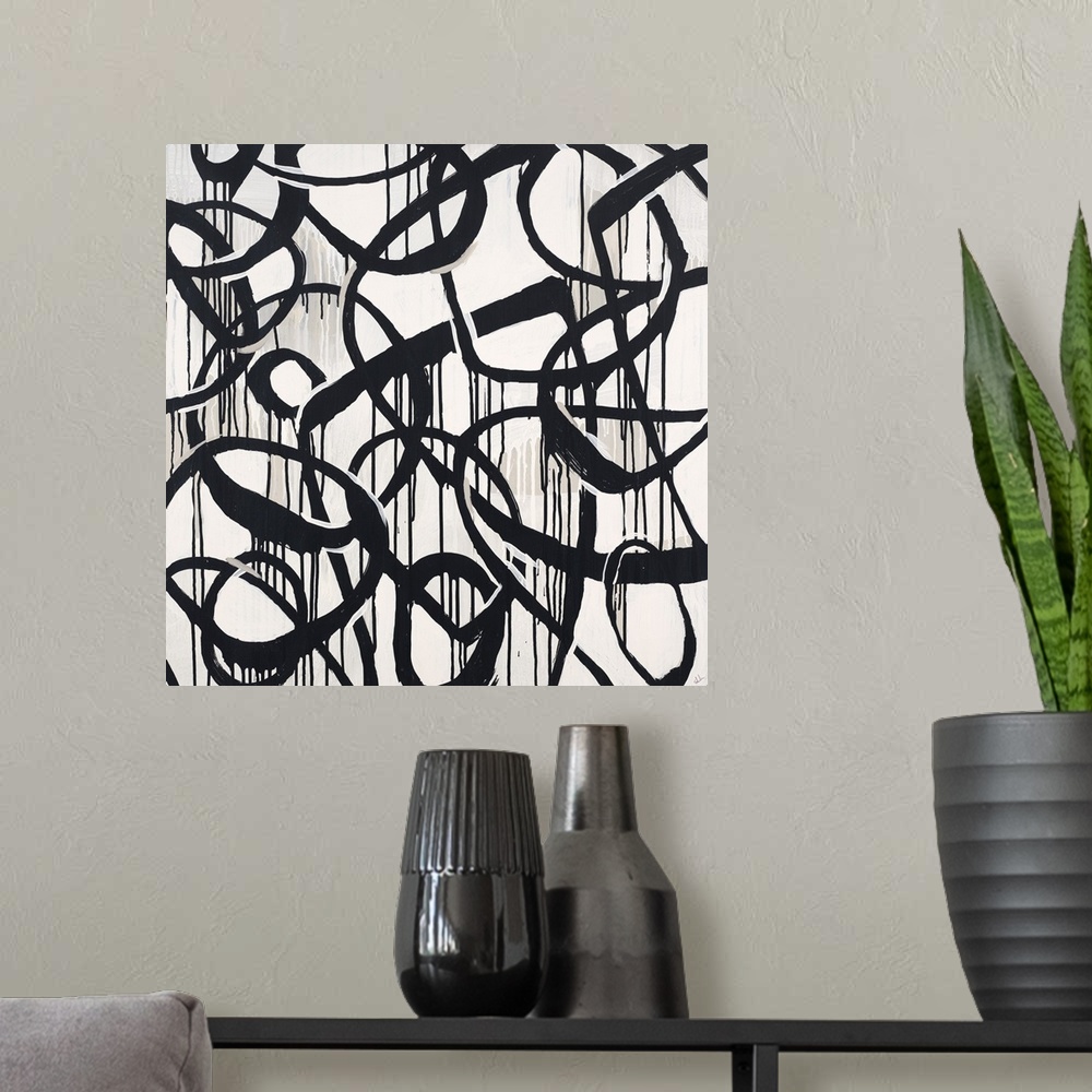 A modern room featuring Contemporary high contrast abstract painting using deep black organic lines in a circular motion.