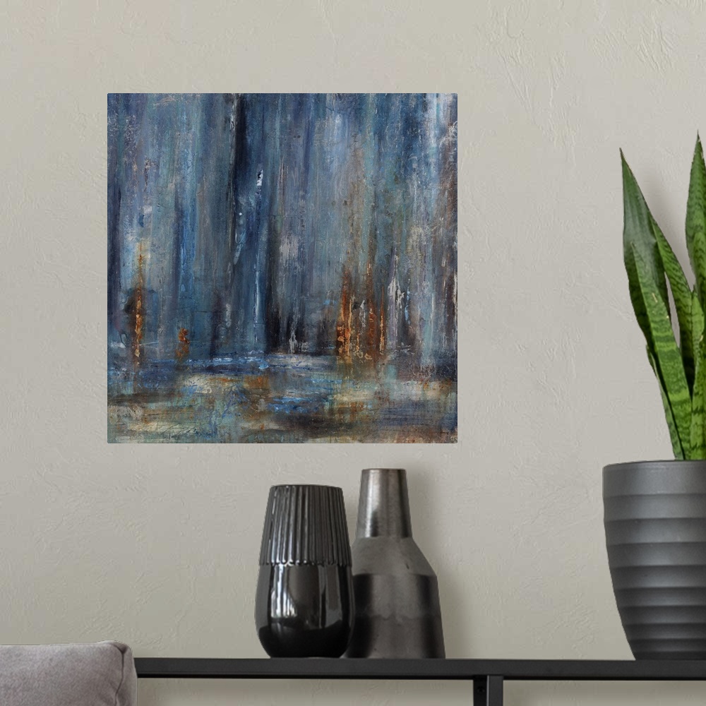 A modern room featuring Abstract painting with dark blue cascading down from the top of the image merging with earthy tones.