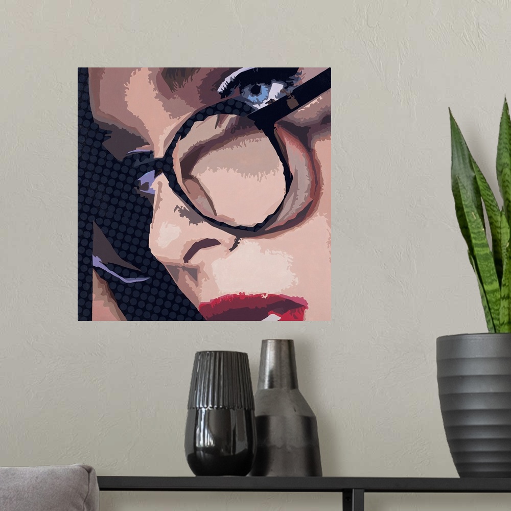 A modern room featuring Close-up square artwork of a woman wearing glasses on a polka dotted background.